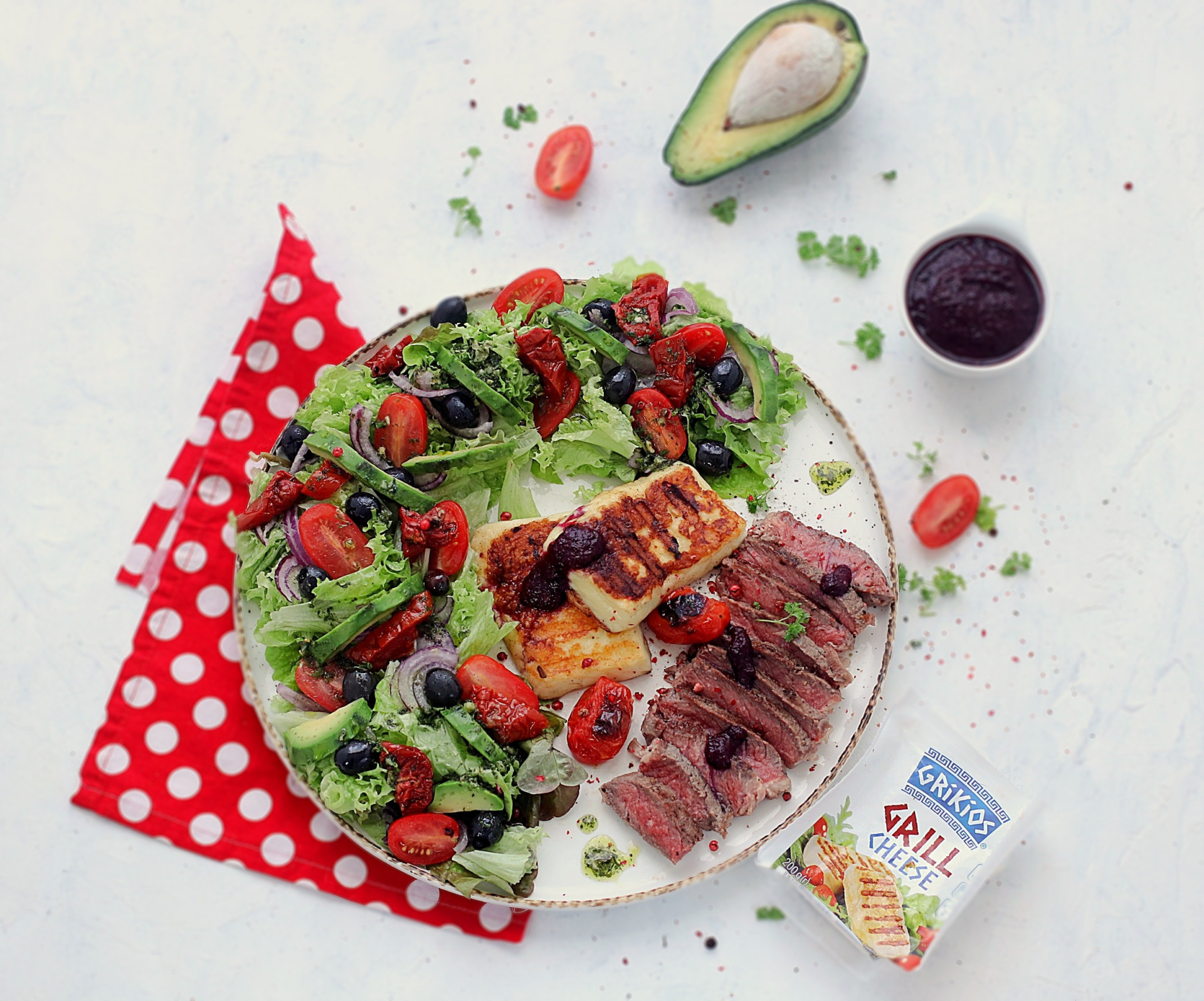 Steak with salad and grilled cheese in a blackberry dressing